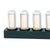 Table clock with four glass tubes and black base, yellow glowing LED display (close-up).