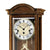 Wanduhr-Zifferblatt im nussbaumfarbenen Gehäuse mit AMS-Logo und Pendelblick