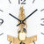 Close-up of wall clock: golden movement with casing and black hands