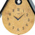 Large detailed view: gold dial with AMS and hands, and cuckoo figure in window