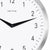 Enlarged view: black clock hands on a white dial with numbers