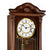 Wall clock face with Roman numerals, gold-colored border, and visible mechanism