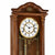 Wooden wall clock in detail: dial with Roman numerals and gold-colored pendulum rod.