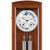 Wooden wall clock with glass front, brown casing, round dial, and pendulum