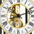 Close-up of the watch movement with golden gears and Roman numerals