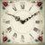 Close-up of the watch dial: white, Roman numerals, and floral ornaments