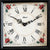 Detail view: Table clock with white dial, Roman numerals, and black hand set