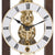 Close-up: Table clock with open brass movement, Roman numerals, and round hands
