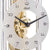 Hermle table clock detail: white dial with numerals and visible brass mechanism.