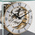 Close-up of the movement of a table clock in a glass case with golden gears and Roman numerals